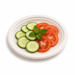 7-inch round bagasse plate served with vegetable pakoras and sweet chilli dipping sauce on a white background.