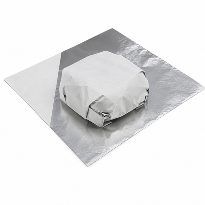 a burger wrapped in foil liner wrap which is a two sided sheet, one side is foil and the other side is white paper