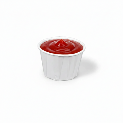 Food Packaging Direct 1oz white paper souffle cup filled with red ketchup, featuring a rolled rim and pleated sides.