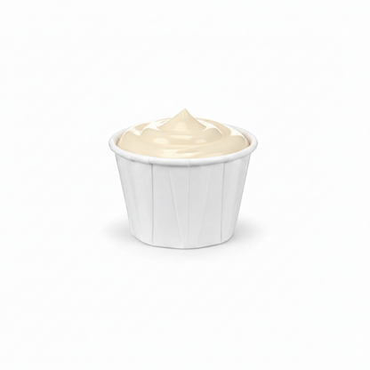 Food Packaging Direct 1oz white paper souffle cup filled with creamy condiment against a clean white background