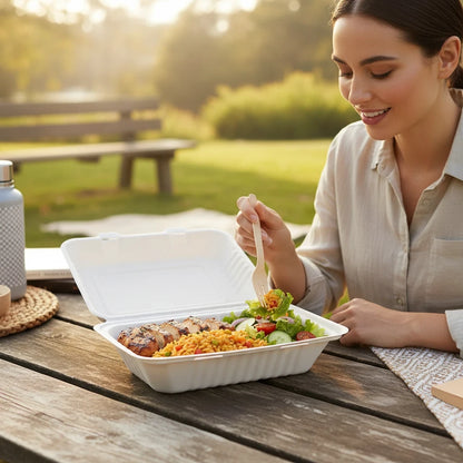 Food Packaging Direct 9x6x3 bagasse clamshell lunch box with a healthy meal, enjoyed outdoors by a woman.