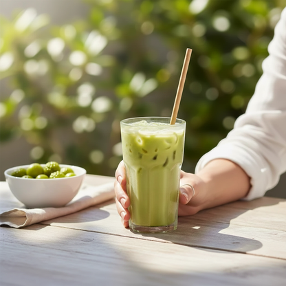 Food Packaging Direct eco-friendly 3-ply kraft paper straw in a glass of iced matcha latte on a sunny outdoor table