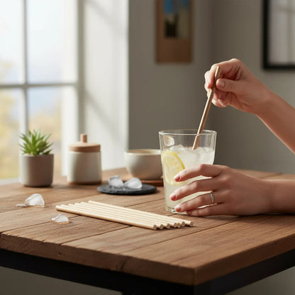 Food Packaging Direct plain kraft paper straws in a glass of iced lemonade on a rustic wooden table